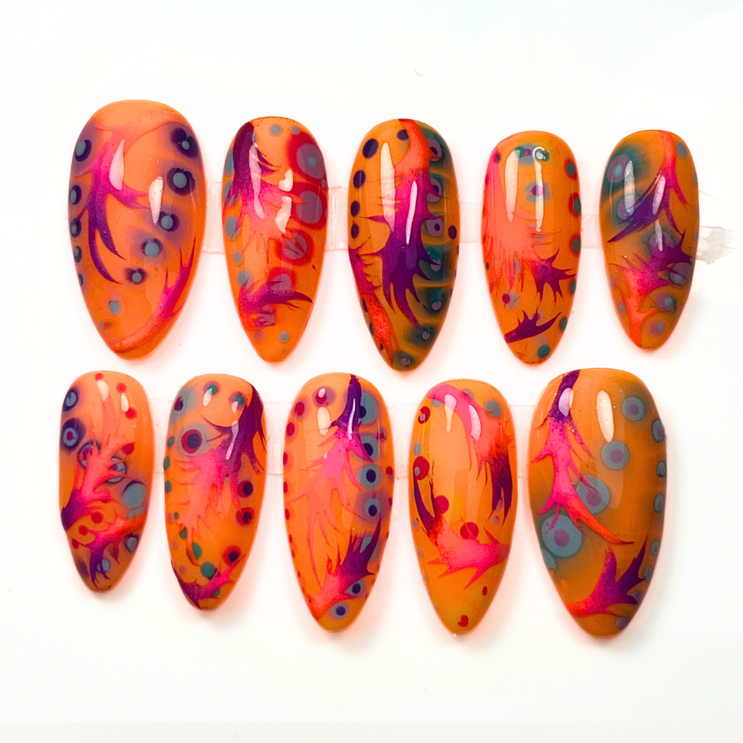 Colourful rainbow swirl press-on nails in a psychedelic sunburst design, hand-painted and custom-made in a 10-piece set for vibrant Y2K-inspired looks.