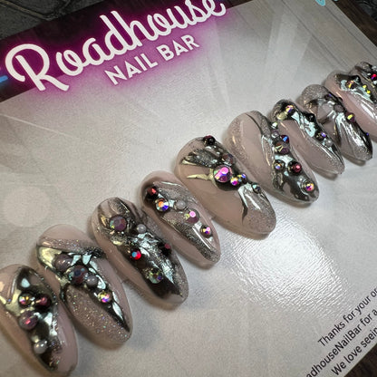 Decorative nails with rhinestones on a Roadhouse Nail Bar tray