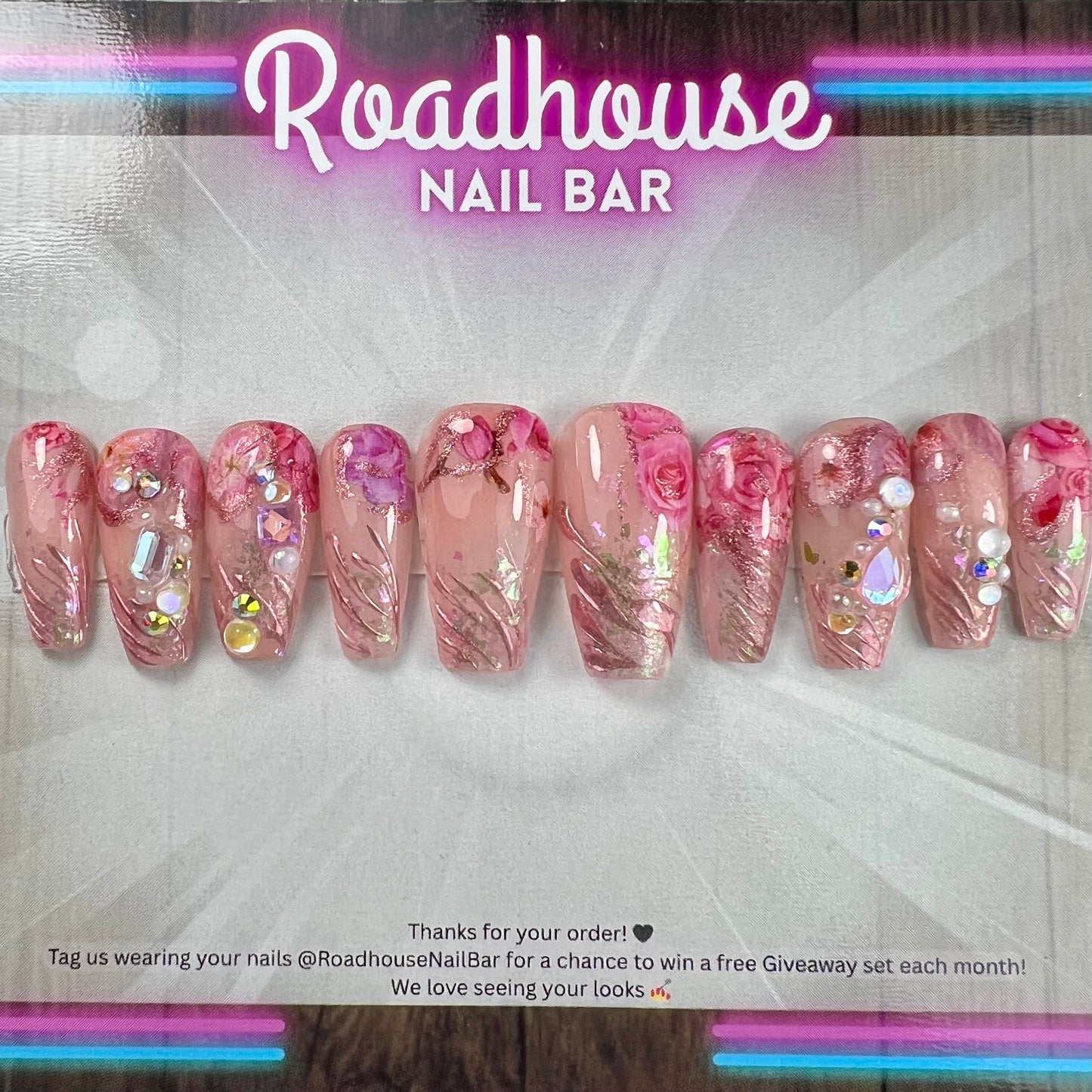 Luxury pink press-on nails featuring 3D roses, pearls and romantic textured detailing.