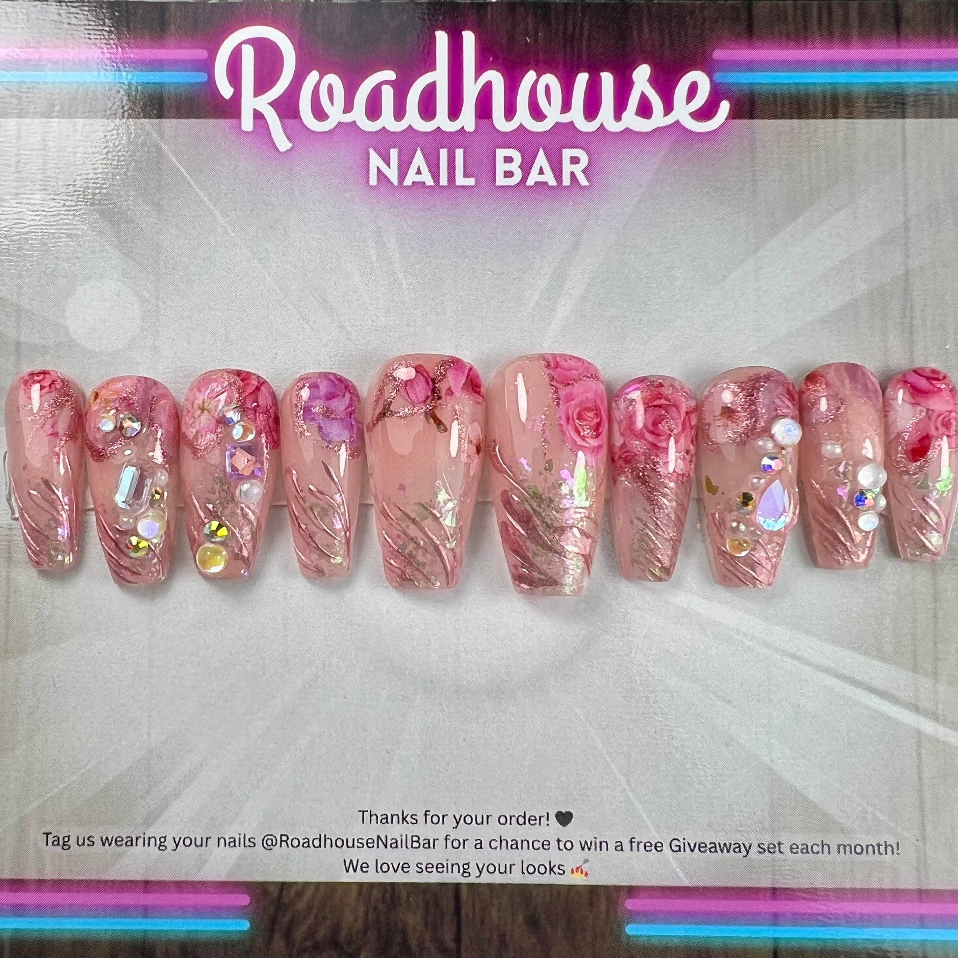 Luxury pink press-on nails featuring 3D roses, pearls and romantic textured detailing.