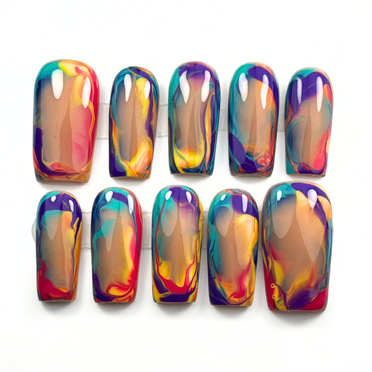 Vibrant hand-painted press-on nails with abstract summer sunset swirls in red, yellow, purple, teal, and orange on a nude base, shown in medium square.
