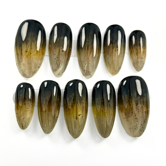 10-piece press-on nail set inspired by wolves, featuring a dark grey to golden brown ombré with claw-like texture and luxe earthy tones. Perfect for witchy, wiccan, and nature-loving styles.

