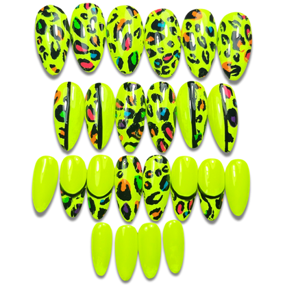 Hand with neon yellow press-on nails in medium almond shape, featuring glossy rainbow leopard print – bold 24-piece set for rave and festival wear
