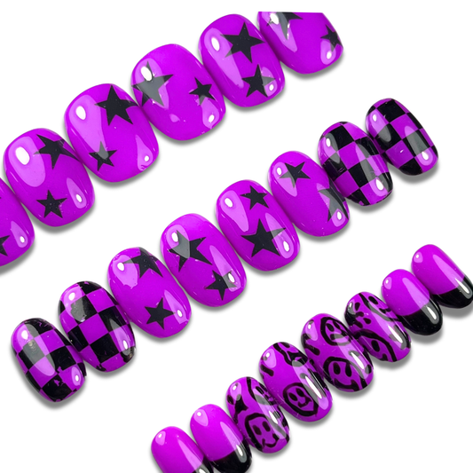 and with purple and black emo press-on nails in short almond shape, featuring smiley face art, checkerboard pattern, and silver accents – 24-piece set